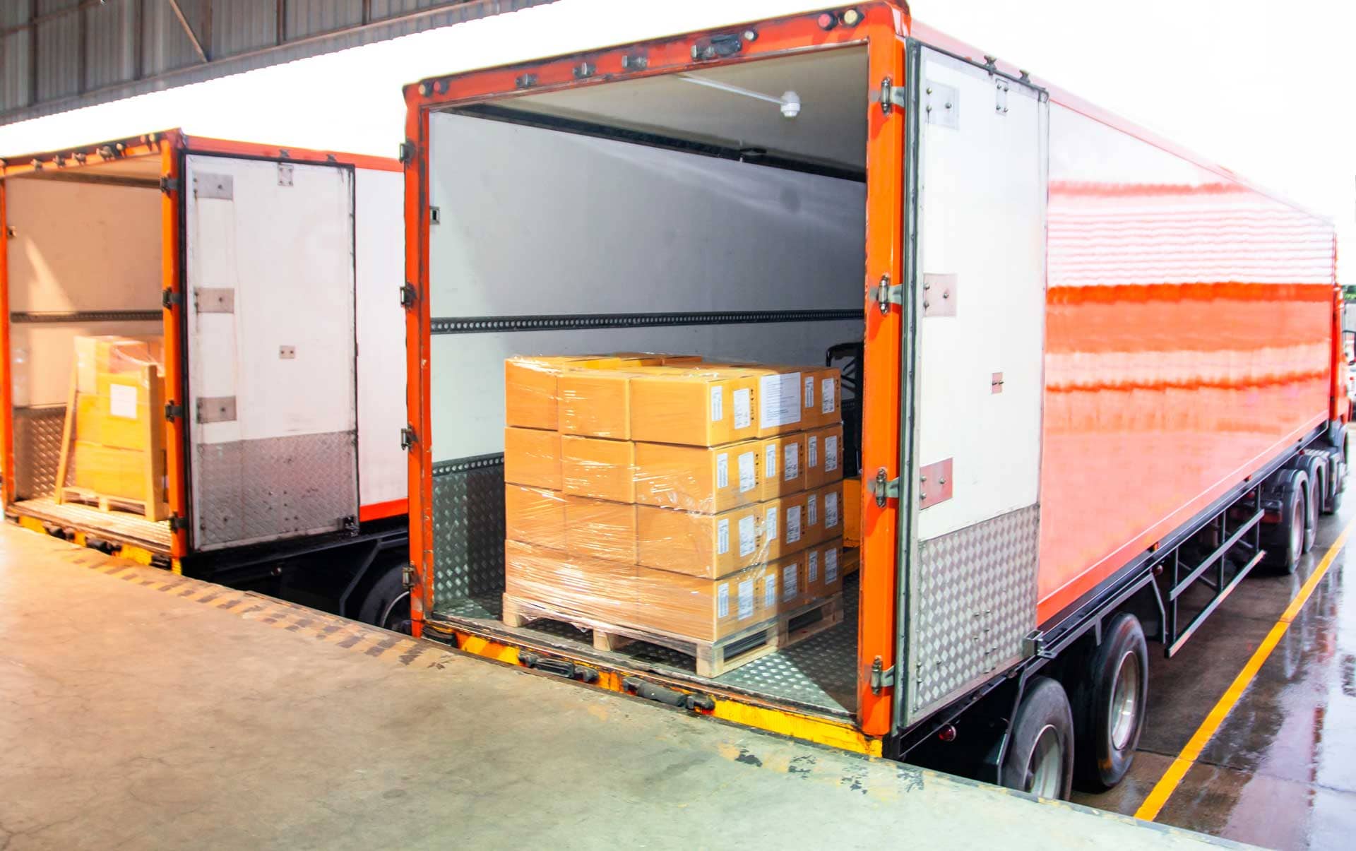 Pallets containing boxes of dry ice being loaded into a truck