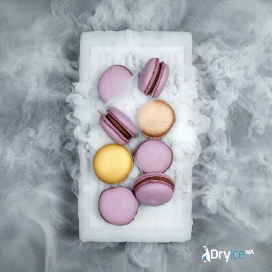A plate of macarons surrounded by decorative dry ice