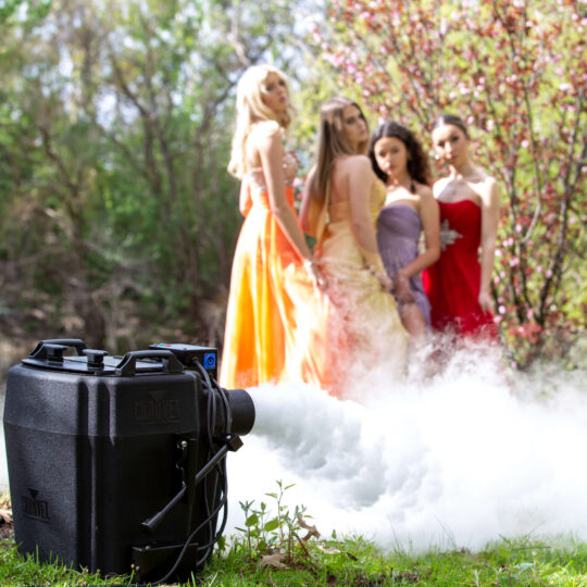 Four young women are posing in front of a dry ice fog machine